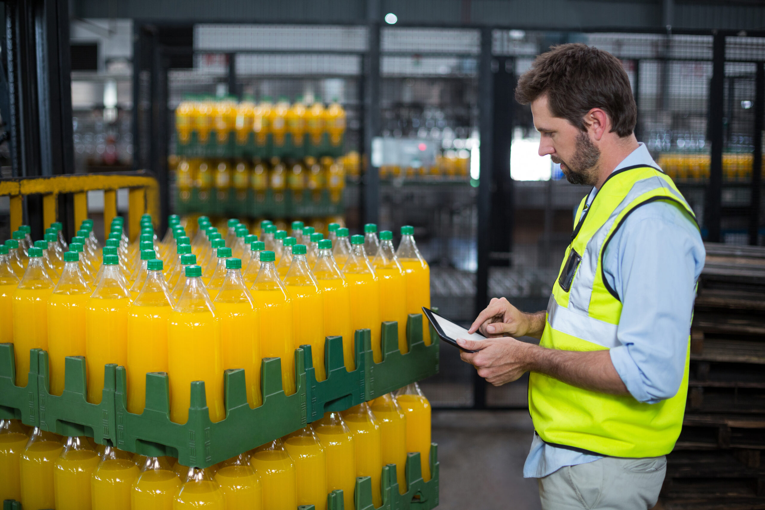 factory-worker-maintaining-record-on-juice-bottles-2026-03-26-11-51-54-utc